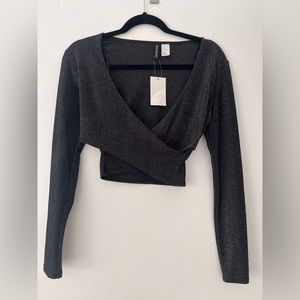 Sexy woman’s cross crop with long sleeves. Black with detailed sparkles